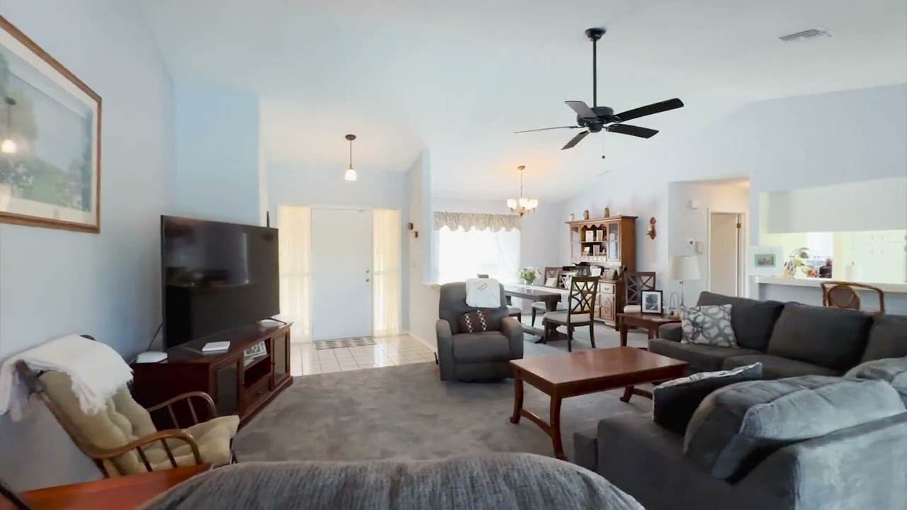 Cover of a lake home at 8367 Apple Orchard Road in Spring Hill, Florida.